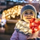 A little girl in winter holding red lights at the Annual Christmas Convoy Belgrade, MT.